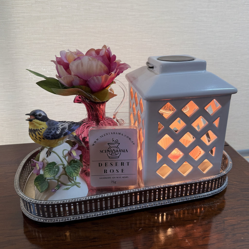 Desert Rose Clamshell Soy Wax Melts image with Trellis Lantern Wax Melt Warmer and decorative trinkets on a tray
