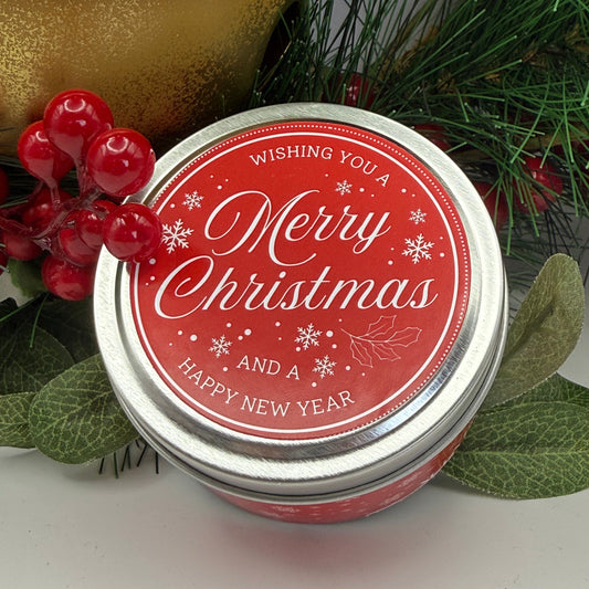 A silver candle travel tin decorated in a Christmas themed label 
