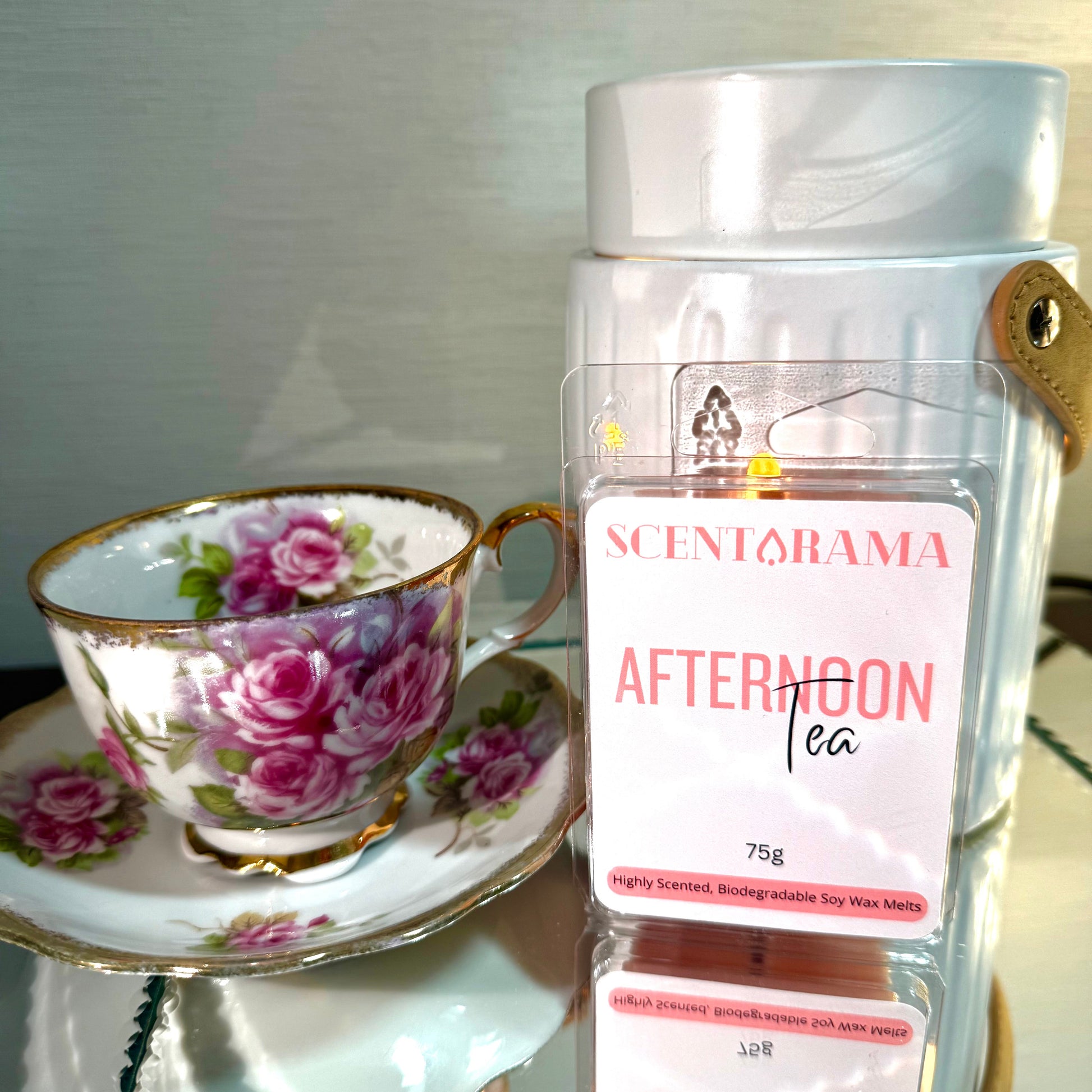 Scentarama Soy Wax Melts product labeled 'Afternoon Tea' by Scentarama next to a floral teacup and saucer.