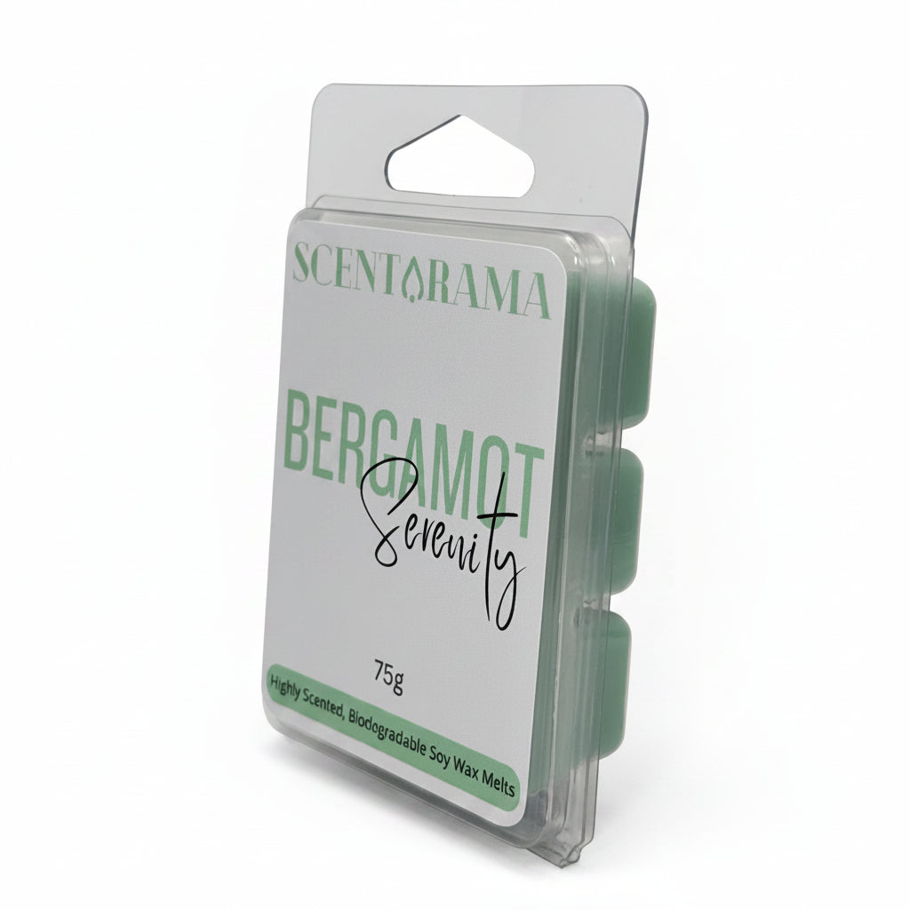 A packaged wax melt product standing upright on a light white background. The clear plastic clamshell package shows a white label with green text reading SCENTARAMA and BERGAMOT Serenity, plus a handwritten-style name in black script