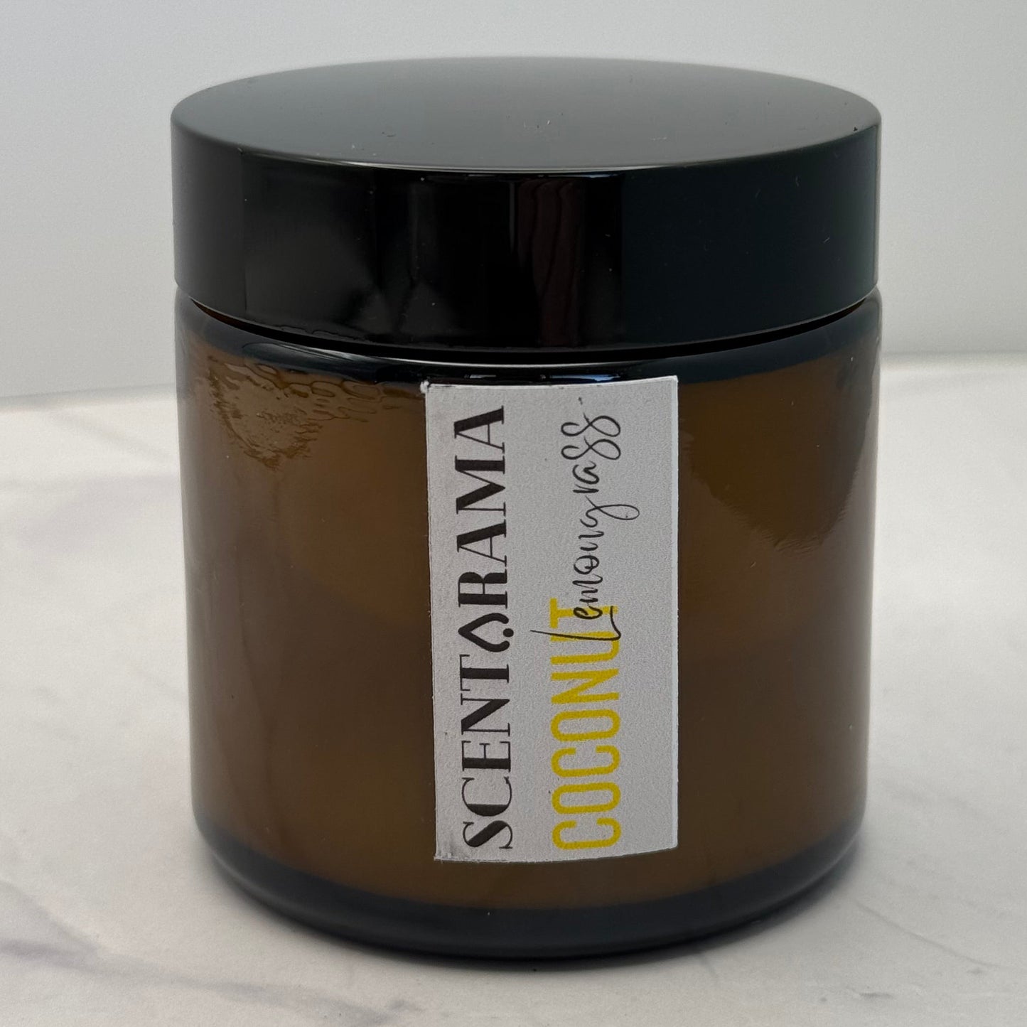 Amber candle Jar with a Scentarama label on a white background