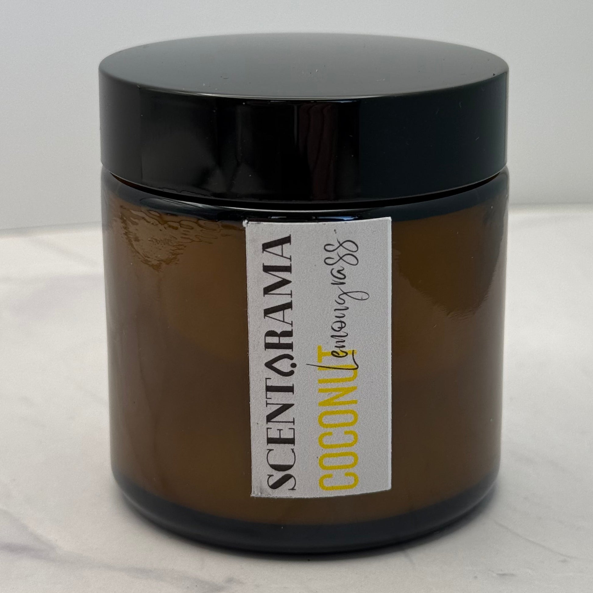Amber candle Jar with a Scentarama label on a white background