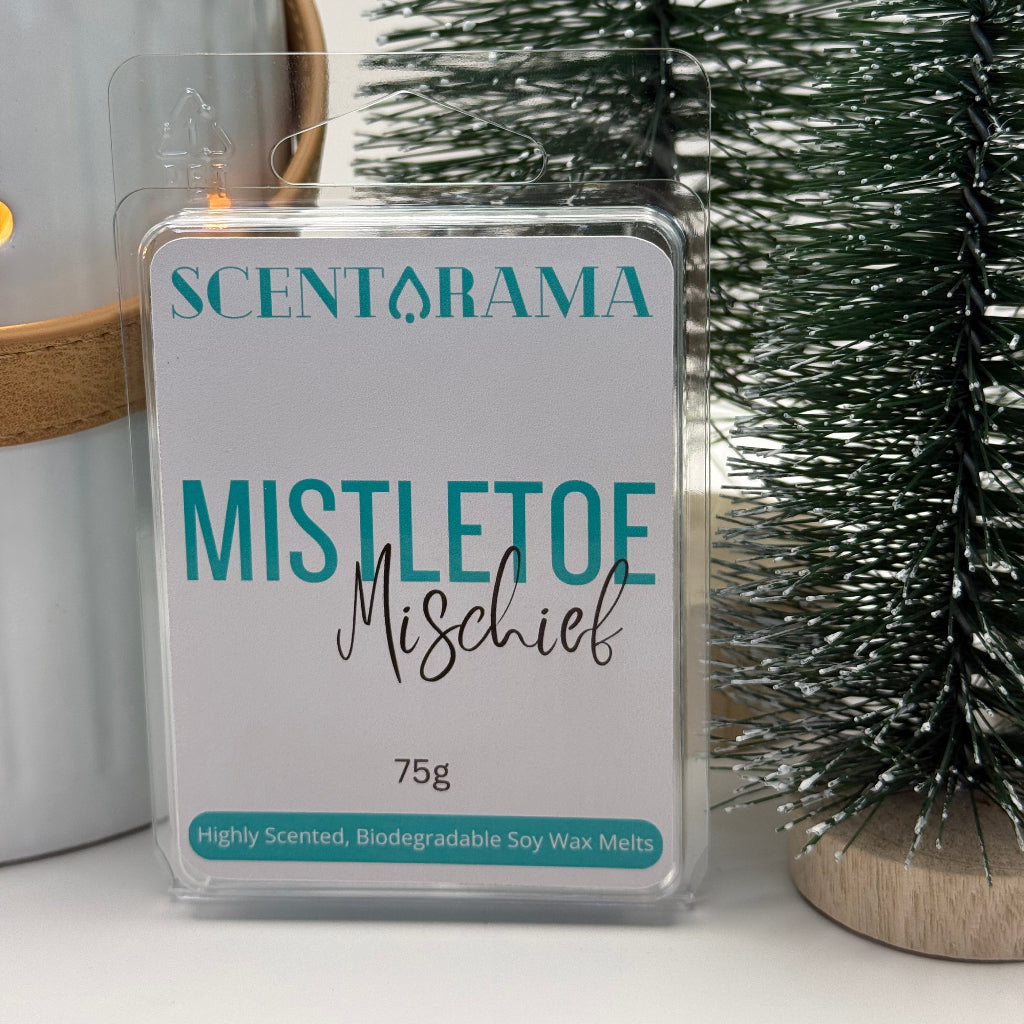 Mistletoe Mischief Soy Wax Melt Clamshell Product Photo with Christmas Props partially in image