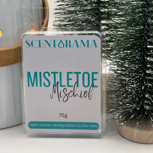Mistletoe Mischief Soy Wax Melt Clamshell Product Photo with Christmas Props partially in image