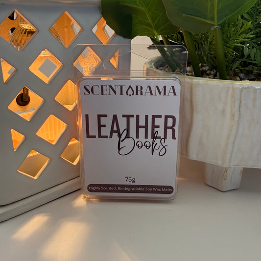 Scentarama Leather Books wax melt packaging on a decorative surface with plants.