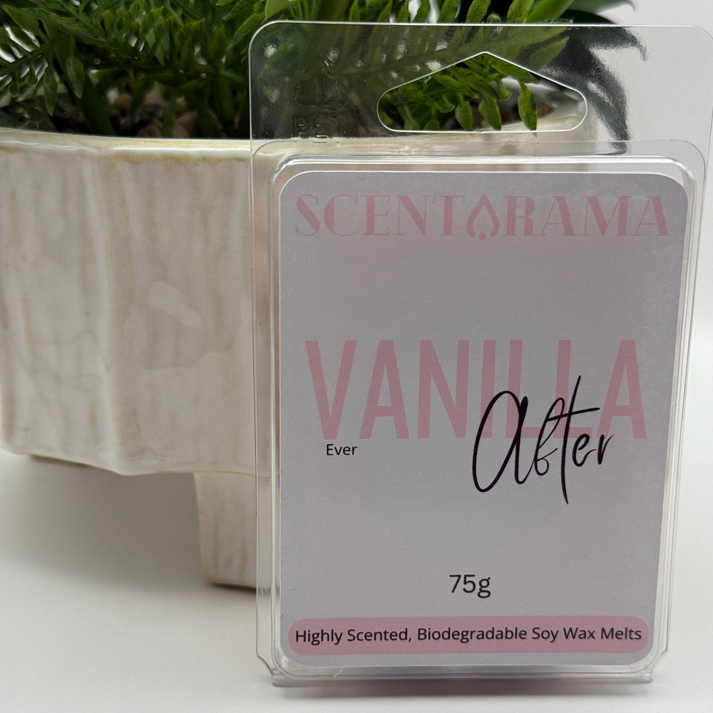A packaged Scentrama 'Vanilla Ever After' soy wax melt, 75g, in a clear plastic clamshell package with a white and pink label, set against a white background with a potted plant in the background.